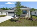 Charming single-Gathering home with a gray garage door and stone accents at 4076 Bannock Ave, Tavares, FL 32778