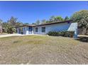 Charming one-story home featuring a blue exterior, with green lawn at 600 Swallow Dr, Casselberry, FL 32707