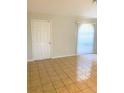 The living room features neutral paint, a front door, light-filtering blinds, and tile flooring at 610 Yak Ct, Kissimmee, FL 34759