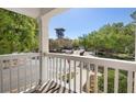 This scenic balcony overlooks a charming street with lush trees and buildings beyond at 675 Celebration Ave, Celebration, FL 34747