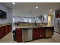 Kitchen with stainless steel appliances, granite countertops, and a breakfast bar at 7664 Wilmington Loop, Kissimmee, FL 34747