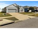 View of single-Gathering home with attached garage, driveway, lawn, and mailbox at 7733 Beridale Ct, Orlando, FL 32818