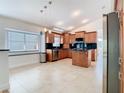 Well-lit kitchen with granite counters, stainless steel appliances, and a kitchen island at 786 Seneca Meadows Rd, Winter Springs, FL 32708