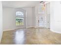 Bright and spacious living room with tile flooring, high ceilings, and large windows at 786 Seneca Meadows Rd, Winter Springs, FL 32708