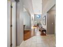 Bright entryway featuring tile and hardwood flooring, leading to a staircase and living area at 1048 Lake Berkley Dr, Kissimmee, FL 34746