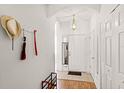 A bright foyer featuring tile and wood flooring, a coat closet, and a stylish light fixture to welcome you home at 1149 S Beach Cir, Kissimmee, FL 34746