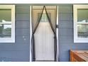 Close-up of the white front door, complemented by a decorative magnetic mesh screen at 1226 Pine St, Orlando, FL 32824