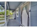 Cozy covered front porch leading to the entrance, equipped with a Ring doorbell and secured with a mesh screen at 1226 Pine St, Orlando, FL 32824