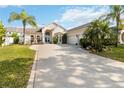 Charming single-story home boasts mature landscaping, a circular driveway, and a welcoming two-car garage at 1923 Lazy Oaks Loop, St Cloud, FL 34771