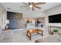 Open concept living room flowing into kitchen with stylish wood accent wall at 194 Henry Steven Dr, Haines City, FL 33844