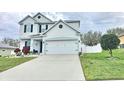 Charming two-story home with landscaped front yard and two-car garage at 2015 Barstow Ln, Dundee, FL 33838