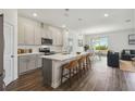 Modern kitchen featuring a large island with bar seating and stainless steel appliances at 2238 Gold Dust Dr, Clermont, FL 34715