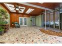 Enclosed sunroom with tile flooring, wood paneling, skylights, and ceiling fans at 224 Pennsylvania Ave, St Cloud, FL 34769