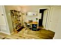 Home office featuring modern desk, shelving, and hardwood floors, great for remote work at 2789 Pleasant Cypress Cir, Kissimmee, FL 34741