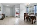 Sunlit dining room with a classic chandelier and a view into the adjacent bedroom at 283 Willow View Dr, Davenport, FL 33896