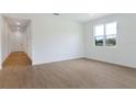 Bright living space with wood-look floors and a large window offering outdoor views at 306 Alexandrite St, Deland, FL 32720