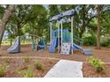 Community playground with slides, climbing structures, and a soft landing surface for children to enjoy outdoor activities at 306 Alexandrite St, Deland, FL 32720