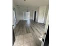 Open-concept living room with hardwood flooring, recessed lighting, and a view to the entryway at 322 Ashburton Way, Kissimmee, FL 34758
