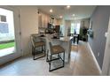 Eat-in kitchen with granite countertops, stainless appliances, tile floors, and view to dining area at 4247 Shackelford Ct, Orlando, FL 32824