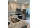 Kitchen featuring granite countertops, stainless appliances, and light gray cabinetry at 4247 Shackelford Ct, Orlando, FL 32824
