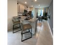 Eat-in kitchen with granite countertops, stainless appliances, tile floors, and view to dining area at 4247 Shackelford Ct, Orlando, FL 32824