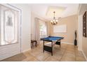 Inviting game room with tiled floors, natural light, and an elegant chandelier at 4910 Culdesac Ct St, St Cloud, FL 34772