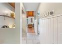 Welcoming hallway with tiled floors, coat hooks, and view into the naturally lit living area at 5316 Burning Tree Dr # A09-2, Orlando, FL 32811