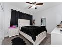 Cozy bedroom with plush carpeting, a comfortable bed, and stylish black-out curtains at 7629 Marietta St, Orlando, FL 32807