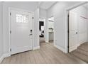 Bright foyer featuring wood-look tile flooring and an ornate glass paneled front door at 7629 Marietta St, Orlando, FL 32807