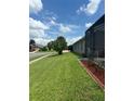 Expansive well-maintained lawn of a single-Gathering home with manicured flower beds at 8074 Santee Dr, Kissimmee, FL 34747