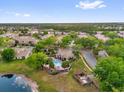 Overhead view of community pool and clubhouse surrounded by lush landscaping in a residential neighborhood at 1225 Coral Coast Dr, Orlando, FL 32824