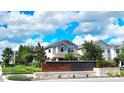 Inviting Enclave at Hamlin community sign with lush landscaping and beautiful blue skies at 15335 Calming Balsam Aly, Winter Garden, FL 34787
