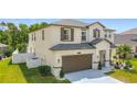 Well-maintained home with a two-car garage, manicured lawn and inviting landscaping at 178 Forest View Dr, Davenport, FL 33896