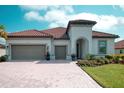 Beautiful home featuring a brick driveway, two-car garage, and meticulously maintained landscaping at 3704 Via Monte Napoleone Dr, Poinciana, FL 34759