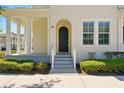 Welcoming front entrance with a classic arched doorway and well-manicured landscaping at 1370 Kiawah St, Celebration, FL 34747
