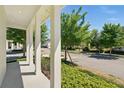 Inviting covered porch with white columns, offering a peaceful view of the neighborhood at 1370 Kiawah St, Celebration, FL 34747