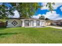 Charming single-story home featuring a well-manicured lawn and a freshly painted exterior at 201 La Paz Dr, Kissimmee, FL 34743