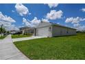 Well-maintained home featuring a green lawn, two-car garage, and inviting curb appeal at 2705 Grandbury Grove Rd, Lakeland, FL 33811