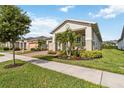 Attractive home with lush landscaping, a two-car garage, and a welcoming covered entryway at 2748 Greenlands St, St Cloud, FL 34772