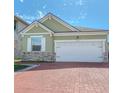 Charming home featuring a brick driveway, a two car garage, and stone veneer on the facade at 2820 Avian Loop, Kissimmee, FL 34741