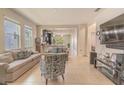 Open floor plan features a spacious living room with tile flooring and views into the kitchen at 2820 Avian Loop, Kissimmee, FL 34741