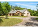 Traditional home with a brick facade, dormer windows, attached garage, and concrete driveway at 3075 Simpson Rd, Kissimmee, FL 34744