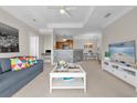 Bright living room with an open floor plan and a view into the kitchen at 3344 Corona Village Way # 308, Orlando, FL 32835
