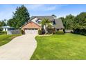 Beautiful home featuring mature trees, a lush green lawn, and a long driveway leading to a two-car garage at 3820 Forest Cir, St Cloud, FL 34772