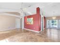 Open-concept living room with tiled floors, ceiling fan, and neutral paint, with an entryway on the left at 4216 Gold Rush Ln, St Cloud, FL 34772