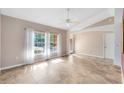 Bright living room with tiled floor, a ceiling fan, and a large window offering plenty of natural light at 4216 Gold Rush Ln, St Cloud, FL 34772