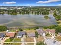 Breathtaking aerial view showcasing a serene lake, surrounded by lush greenery and residential homes at 4343 Lake Richmond Dr, Orlando, FL 32811