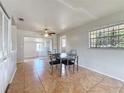 Cozy dining room featuring tile floors, a ceiling fan, and a window with decorative bars at 4343 Lake Richmond Dr, Orlando, FL 32811