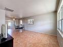 Bright living room with neutral walls, tile flooring, and a sliding glass door to a patio at 4343 Lake Richmond Dr, Orlando, FL 32811