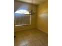 Cozy dining room with neutral walls, tile flooring, and hanging chandelier at 448 Cinnamon Dr, Kissimmee, FL 34759